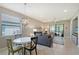 Open concept living room with dining area and abundant natural light at 1318 Ballota Ln, North Port, FL 34289