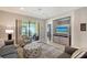 Comfortable living room with TV and slider to screened porch with ceiling fan at 1318 Ballota Ln, North Port, FL 34289