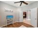 Open room showing a view through an open door to the kitchen, featuring a ceiling fan and modern furnishings at 1318 Ballota Ln, North Port, FL 34289
