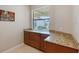 Office with wooden cabinetry and granite countertops at 1318 Ballota Ln, North Port, FL 34289