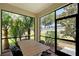 Enclosed patio with a table and chairs, offering a relaxed outdoor dining and living space at 1318 Ballota Ln, North Port, FL 34289