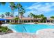 Beautiful community pool with lush landscaping and palm trees at 1318 Ballota Ln, North Port, FL 34289
