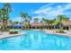 Stunning community pool with a tower feature surrounded by palm trees at 1318 Ballota Ln, North Port, FL 34289