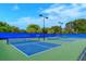 Outdoor tennis courts featuring a green and blue color scheme at 1318 Ballota Ln, North Port, FL 34289