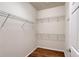 Walk-in closet featuring wire shelving and wood-look flooring, providing ample storage space at 1318 Ballota Ln, North Port, FL 34289
