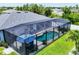 Aerial view of a screened-in pool and backyard showcasing outdoor living at its finest at 13348 Boabadilla Ln, Port Charlotte, FL 33981