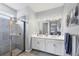 Modern bathroom with double vanity, glass shower door, and contemporary fixtures and decor at 13348 Boabadilla Ln, Port Charlotte, FL 33981
