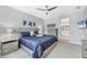 Relaxing bedroom with ensuite bathroom view, blue decor, ceiling fan, and soft natural light at 13348 Boabadilla Ln, Port Charlotte, FL 33981