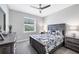Bedroom with natural light, ceiling fan, a queen bed, and gray-toned furniture at 13348 Boabadilla Ln, Port Charlotte, FL 33981