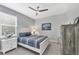 Cozy bedroom with white and blue decor, ceiling fan, and view of the window and dresser at 13348 Boabadilla Ln, Port Charlotte, FL 33981