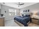 Comfortable bedroom with large window for natural light, ceiling fan, and modern decor at 13348 Boabadilla Ln, Port Charlotte, FL 33981