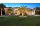 Charming home featuring a manicured lawn, elegant landscaping, and warm exterior lighting at 13348 Boabadilla Ln, Port Charlotte, FL 33981