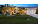 Beautiful home with a well-kept lawn, lush palm trees, and ample outdoor space at 13348 Boabadilla Ln, Port Charlotte, FL 33981