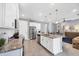 Bright kitchen with white cabinets, granite countertops, stainless steel appliances, and an island with a sink at 13348 Boabadilla Ln, Port Charlotte, FL 33981