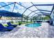 Inviting screened-in pool area with sun loungers and umbrellas, ideal for outdoor relaxation and entertainment at 13348 Boabadilla Ln, Port Charlotte, FL 33981
