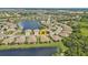 Aerial view of the community showcasing a lake, landscaping, and home's proximity to the water at 1339 Backspin Dr, Englewood, FL 34223