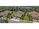 Aerial view showcases the home's manicured landscaping, brick driveway, and waterfront views at 1339 Backspin Dr, Englewood, FL 34223