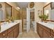 Bathroom with double sinks, a glass-enclosed shower, and decorative accents at 1339 Backspin Dr, Englewood, FL 34223