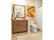 Cozy bathroom showcasing wood vanity with a framed mirror and decorative shower curtain at 1339 Backspin Dr, Englewood, FL 34223