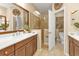 Stylish bathroom with double sinks, a glass-enclosed shower, and decorative accents at 1339 Backspin Dr, Englewood, FL 34223
