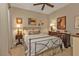 Bedroom with neutral decor, ceiling fan, lamps, and framed artwork at 1339 Backspin Dr, Englewood, FL 34223