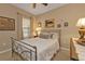 Comfortable bedroom featuring a metal bed frame, neutral walls, and a ceiling fan at 1339 Backspin Dr, Englewood, FL 34223