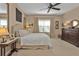 Bedroom featuring a ceiling fan, framed artwork, and a traditional wood dresser at 1339 Backspin Dr, Englewood, FL 34223