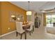 Open-concept dining area featuring a wooden table, seating for four, and bright accents at 1339 Backspin Dr, Englewood, FL 34223