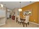 A view of the dining room, with open floor plan, view into the kitchen, and tan color scheme at 1339 Backspin Dr, Englewood, FL 34223