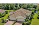 Beautiful exterior showcasing a tile roof, three-car garage, and lush landscaping at 1339 Backspin Dr, Englewood, FL 34223