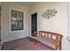 Cozy front porch featuring a bench and decorative rug, creating a welcoming entrance at 1339 Backspin Dr, Englewood, FL 34223