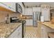 Well-equipped kitchen with granite countertops, stainless steel appliances, and modern fixtures at 1339 Backspin Dr, Englewood, FL 34223