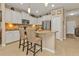 Bright kitchen featuring granite countertops, stainless steel appliances, and breakfast bar with seating at 1339 Backspin Dr, Englewood, FL 34223