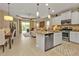 Bright, open kitchen featuring modern stainless steel appliances and a center island at 1339 Backspin Dr, Englewood, FL 34223