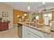 Granite counter island with sink in this open space including the kitchen, dinette, and living room at 1339 Backspin Dr, Englewood, FL 34223
