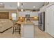 Charming kitchen with granite countertops, stainless steel appliances, island, and adjacent living space at 1339 Backspin Dr, Englewood, FL 34223