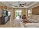 Light and airy living room showcasing an open floor plan and sliding doors to the lanai at 1339 Backspin Dr, Englewood, FL 34223
