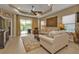 Spacious living room with coffered ceilings, neutral tones, and sliding glass doors to the patio at 1339 Backspin Dr, Englewood, FL 34223