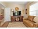 Comfortable living room featuring wood floors, leather sofa, and open layout at 1339 Backspin Dr, Englewood, FL 34223