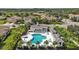 Community pool with ample seating, lush landscaping, and a spa at 1339 Backspin Dr, Englewood, FL 34223