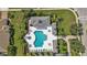Aerial shot of a community pool area surrounded by beautiful landscaping and seating at 1339 Backspin Dr, Englewood, FL 34223