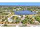 Expansive aerial view of a serene lake community with beautiful homes, lush greenery, and a tranquil atmosphere at 15092 Chinook Way, Port Charlotte, FL 33981
