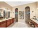 Elegant bathroom with granite countertops, dual sinks and two separate tiled walk-in showers at 15092 Chinook Way, Port Charlotte, FL 33981