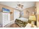 Cozy bedroom with ceiling fan, wall decor and double door closet at 15092 Chinook Way, Port Charlotte, FL 33981