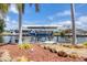 Boat dock with boat lift on a sunny day, complemented by tropical landscaping at 15092 Chinook Way, Port Charlotte, FL 33981