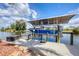 Boat dock featuring a covered boat lift, cleaning station and dockside storage at 15092 Chinook Way, Port Charlotte, FL 33981