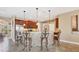Stylish kitchen bar area with stone accents, pendant lighting, and seating for casual dining at 15092 Chinook Way, Port Charlotte, FL 33981