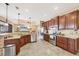 Modern kitchen with stainless steel appliances, granite countertops, and a view of the living room at 15092 Chinook Way, Port Charlotte, FL 33981