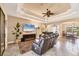 Spacious living area with tile flooring, a ceiling fan, and a view of the dining area at 15092 Chinook Way, Port Charlotte, FL 33981