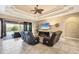 Comfortable living room featuring a fireplace and sliding glass doors leading to the outdoor pool area at 15092 Chinook Way, Port Charlotte, FL 33981